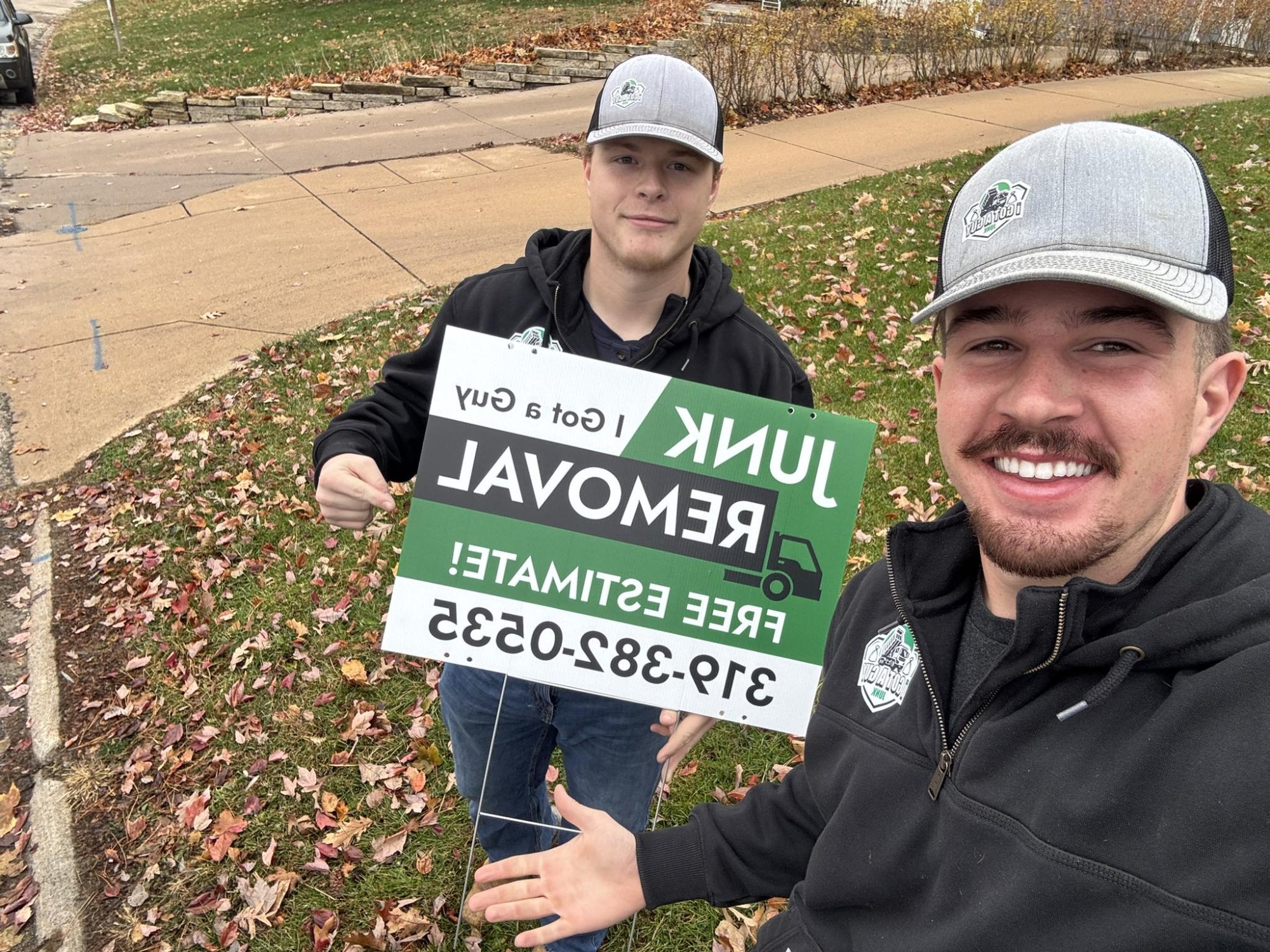 I Got a Guy team holding yard sign